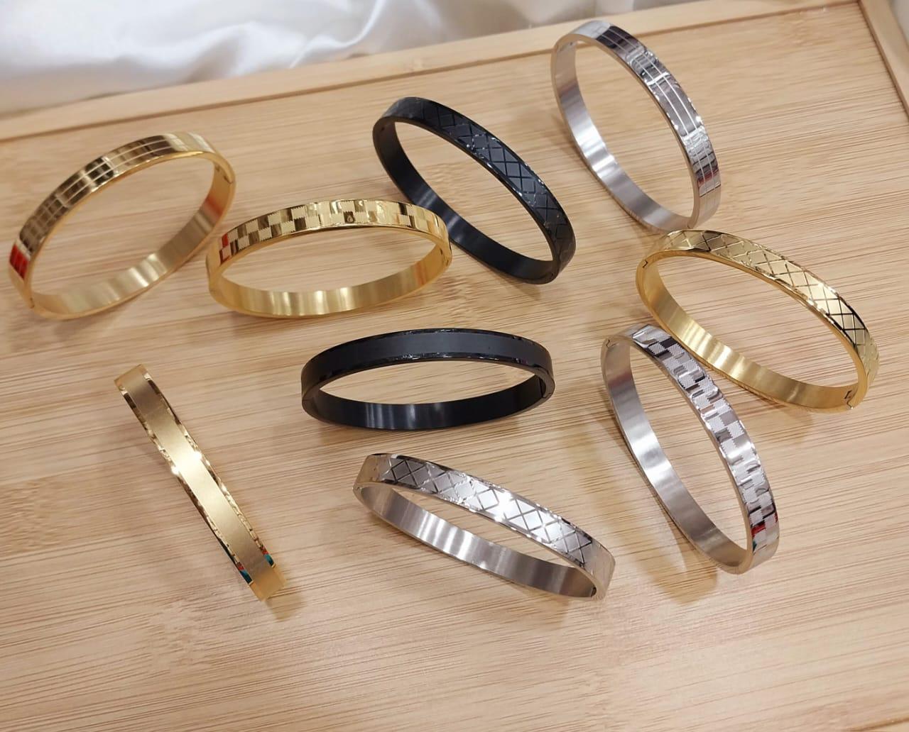 50f85f48bd8778b7c73382ce1ce9586a.jpeg Premium Unisex Geometric Bangle Collection - 18K Gold, Silver & Matte Black Stainless Steel Cuffs with Mixed Textures & Engraved Designs - Image 1
